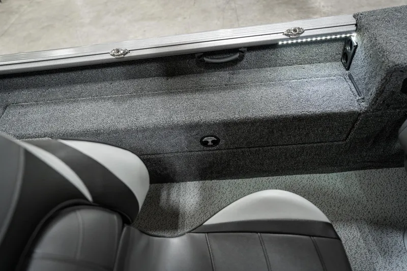 Slide: The Image of Interior view of 2025 Lund 1875 Impact boat with gray seating and storage compartment. - 26