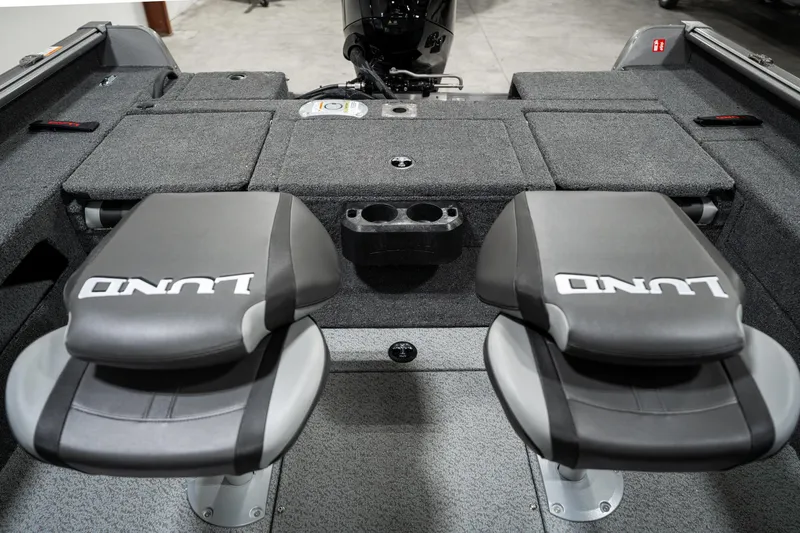 Slide: The Image of 2025 Lund 1875 Impact boat interior with two cushioned seats and storage compartments. - 29