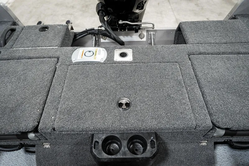 Slide: The Image of 2025 Lund 1875 Impact boat interior with carpeted storage compartments and cup holders. - 30