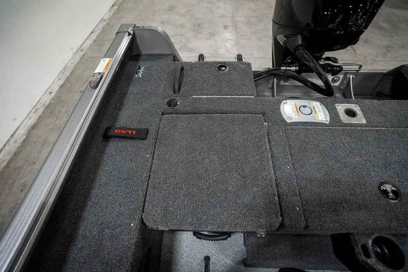 Slide: The Image of 2025 Lund 1875 Impact boat interior with storage compartments and motor. - 32