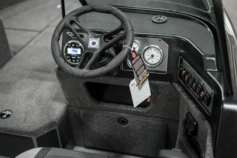 Slide: The Image of 2025 Lund 1875 Impact boat dashboard with steering wheel and gauges. - 35