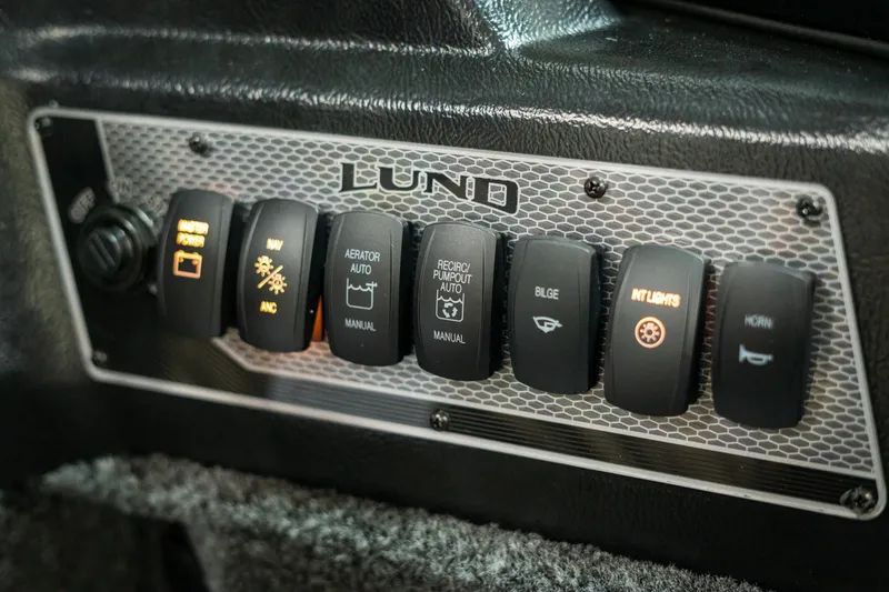 Slide: The Image of Control panel of 2025 Lund 1875 Impact boat with various switches and labels. - 40