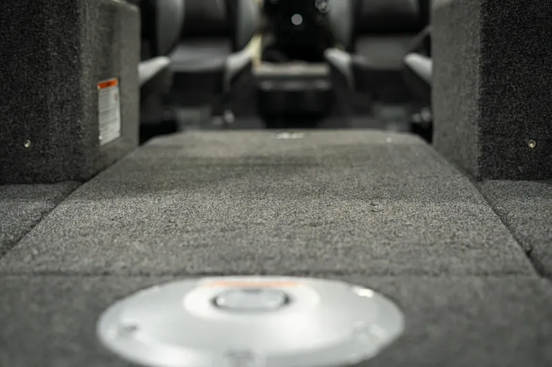 Slide: The Image of Interior view of 2025 Lund 1875 Impact boat, featuring carpeted flooring and storage compartments. - 47