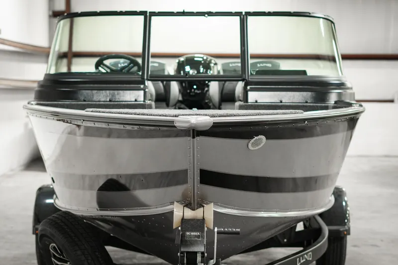 Slide: The Image of 2025 Lund 1875 Impact boat in a garage, front view. - 8