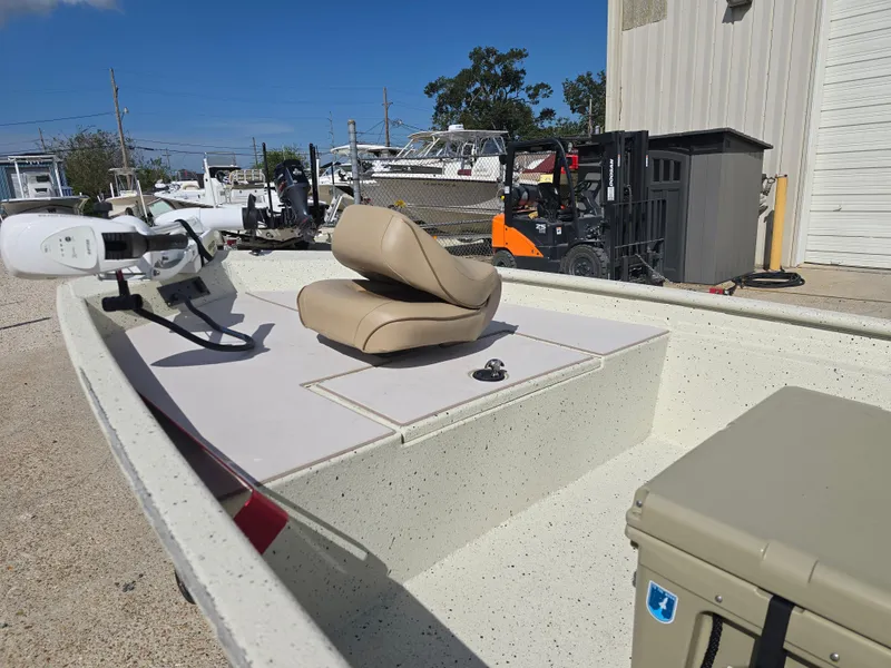 Slide: The Image of 2020 Xpress XP18CC boat with beige seating and equipment, parked outdoors. - 10