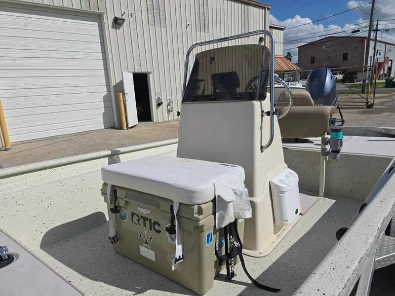 Slide: The Image of 2020 Xpress XP18CC boat with console and RTIC cooler on deck. - 11