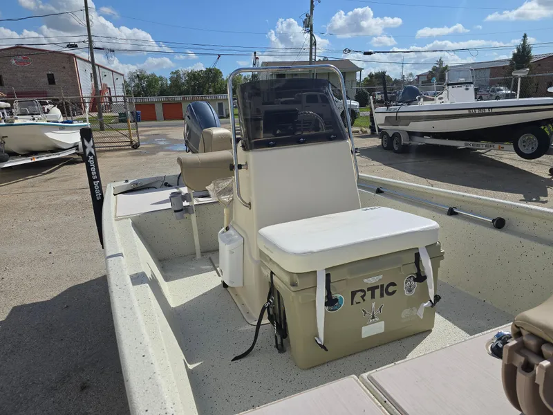 Slide: The Image of 2020 Xpress XP18CC boat with RTIC cooler, parked outdoors under a sunny sky. - 12