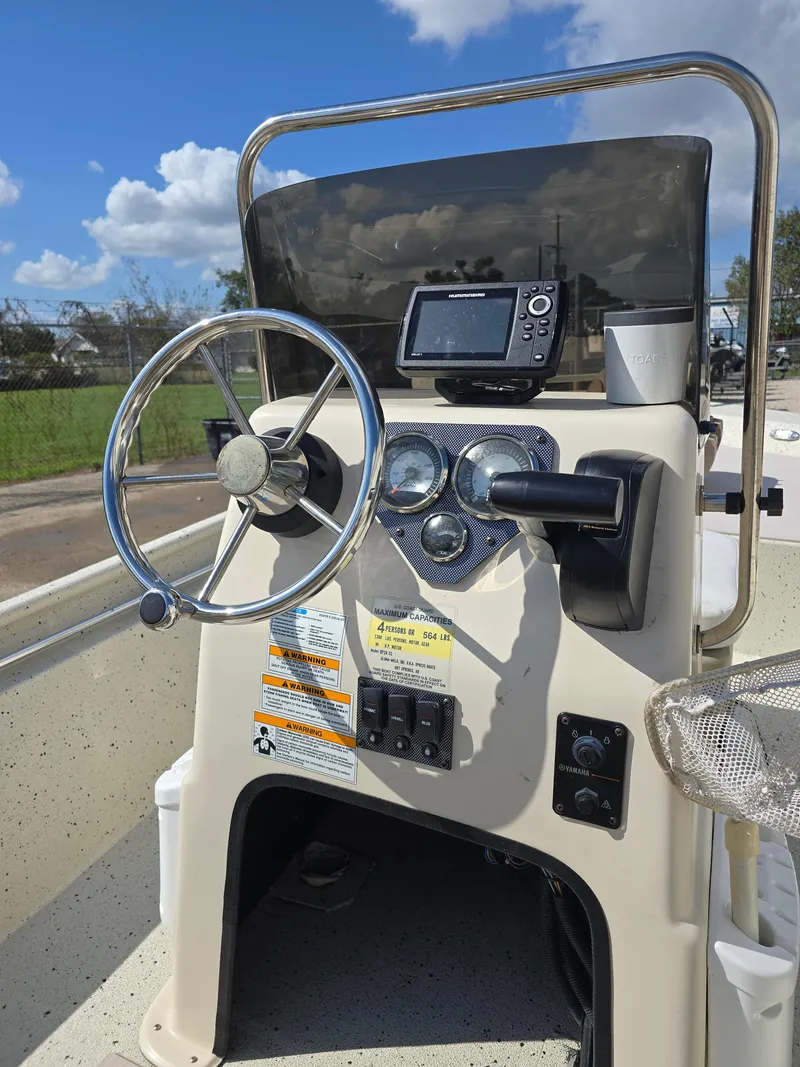 Slide: The Image of 2020 Xpress XP18CC boat console with steering wheel and navigation system. - 14