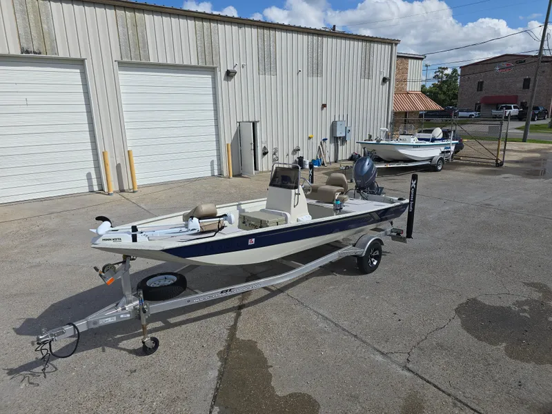 Slide: The Image of 2020 Xpress XP18CC boat on trailer outside a warehouse. - 2