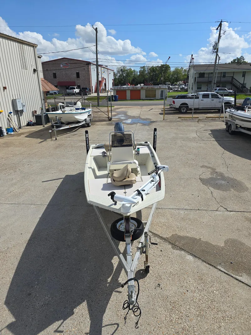Slide: The Image of 2020 Xpress XP18CC boat in a parking lot under a clear blue sky. - 4