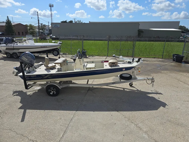 Slide: The Image of 2020 Xpress XP18CC boat on trailer, parked outdoors under a clear sky. - 6