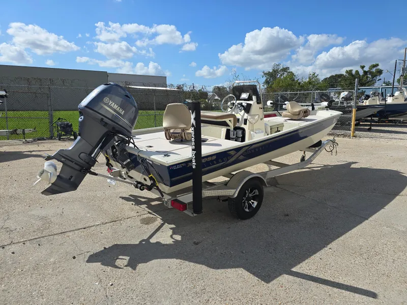 Slide: The Image of 2020 Xpress XP18CC boat with Yamaha outboard motor on trailer, parked outdoors. - 7