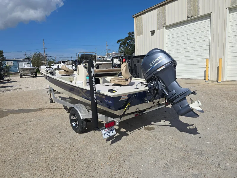 Slide: The Image of 2020 Xpress XP18CC boat with Yamaha outboard motor parked outside a garage. - 9