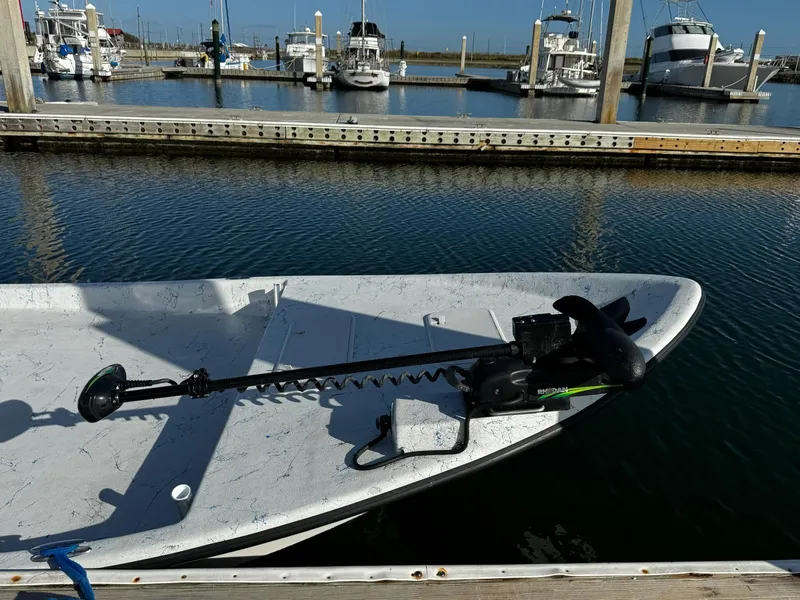 Slide: The Image of 2024 Mowdy 25 Catamaran docked at marina with trolling motor. - 11