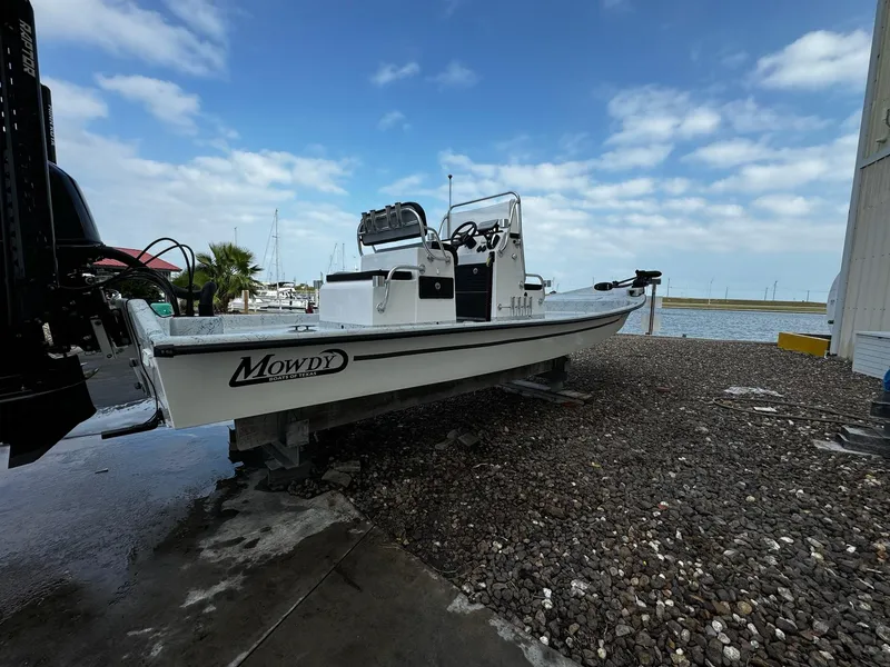 Slide: The Image of 2024 Mowdy 25 Catamaran boat on gravel near marina, under cloudy sky. - 14