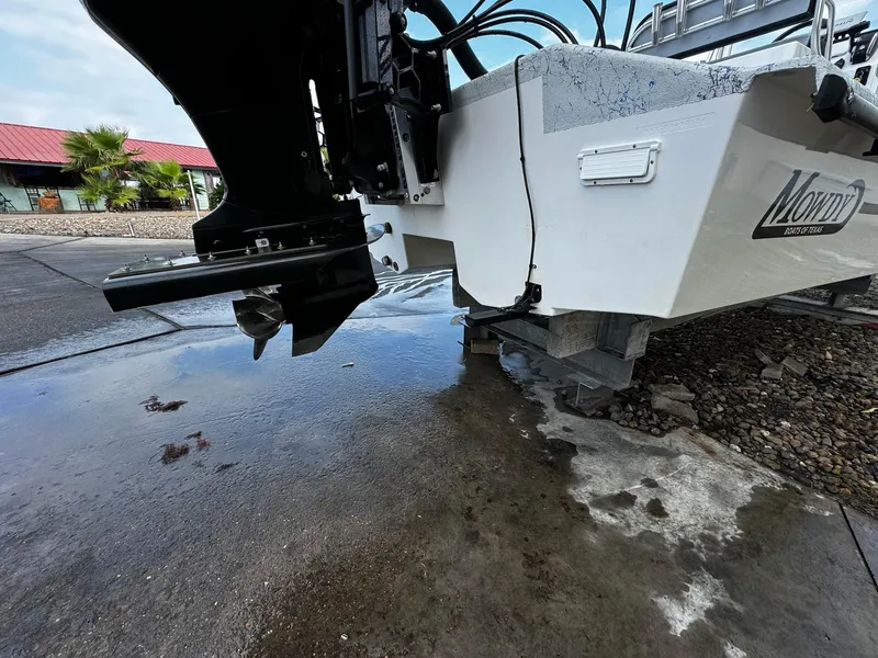 Slide: The Image of 2024 Mowdy 25 Catamaran boat on concrete, showcasing rear view and motor. - 16