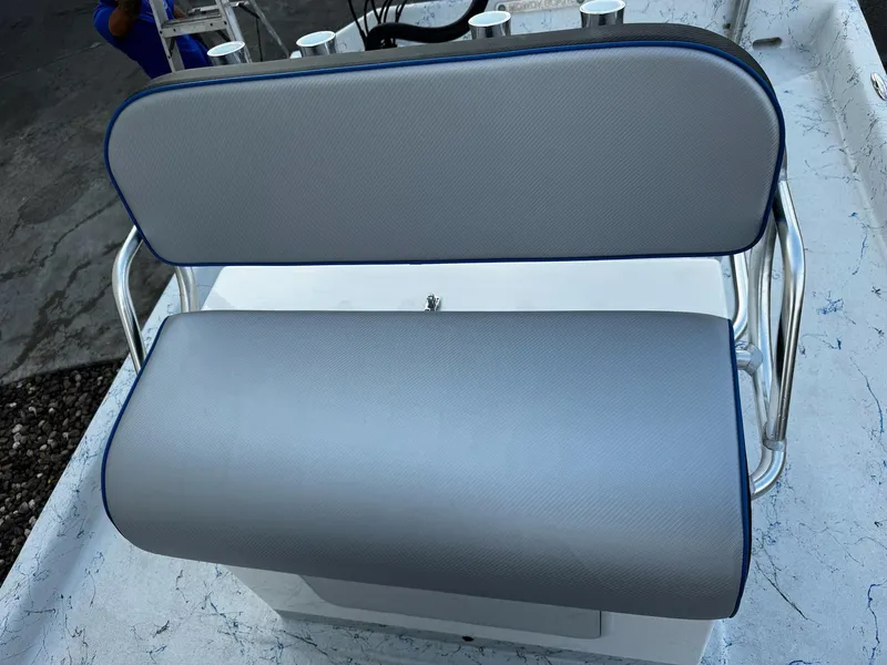 Slide: The Image of 2024 Mowdy 25 Catamaran boat seat with gray upholstery and stainless steel frame. - 17