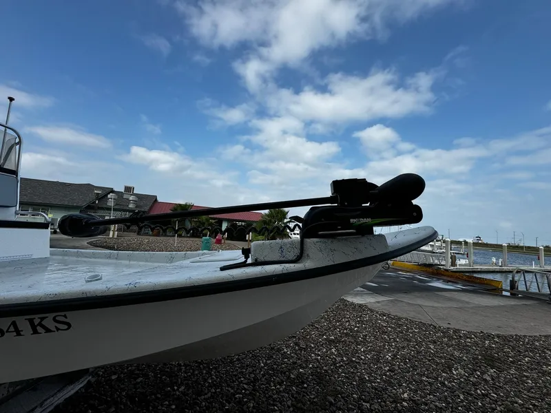 Slide: The Image of 2024 Mowdy 25 Catamaran boat docked under a partly cloudy sky. - 20