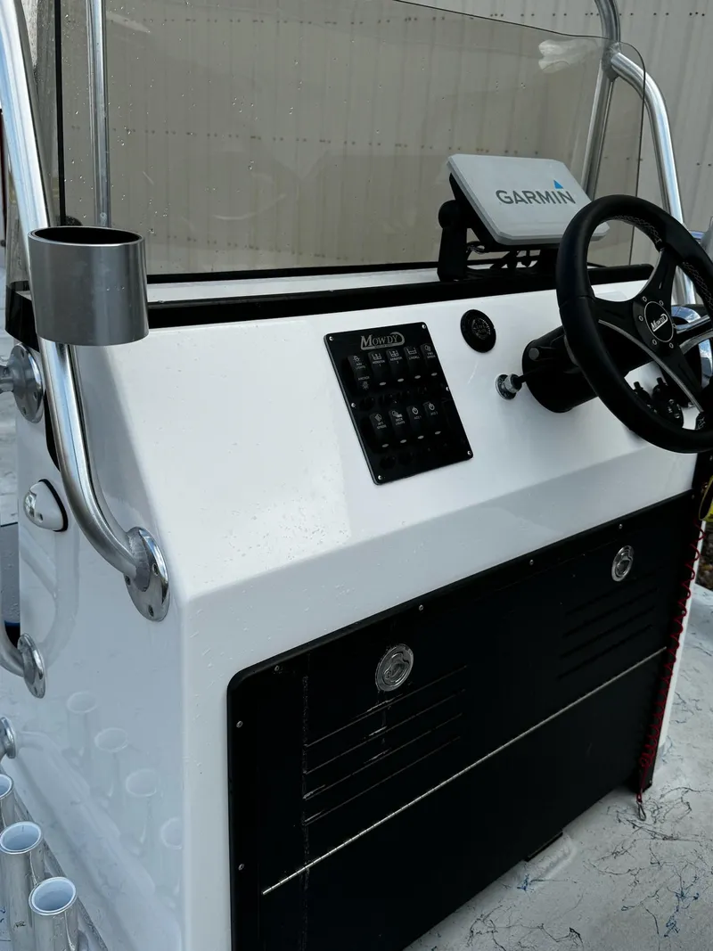 Slide: The Image of 2024 Mowdy 25 Catamaran boat console with steering wheel and Garmin device. - 21