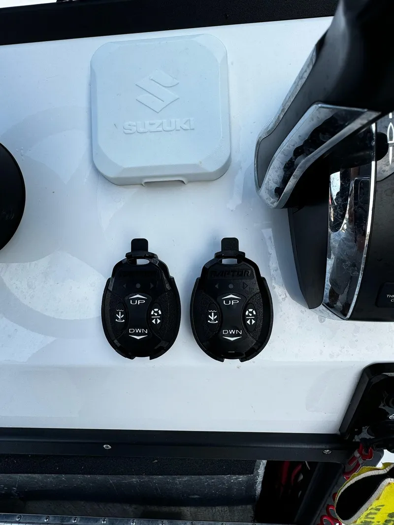Slide: The Image of 2024 Mowdy 25 Catamaran controls with Suzuki components on dashboard. - 25