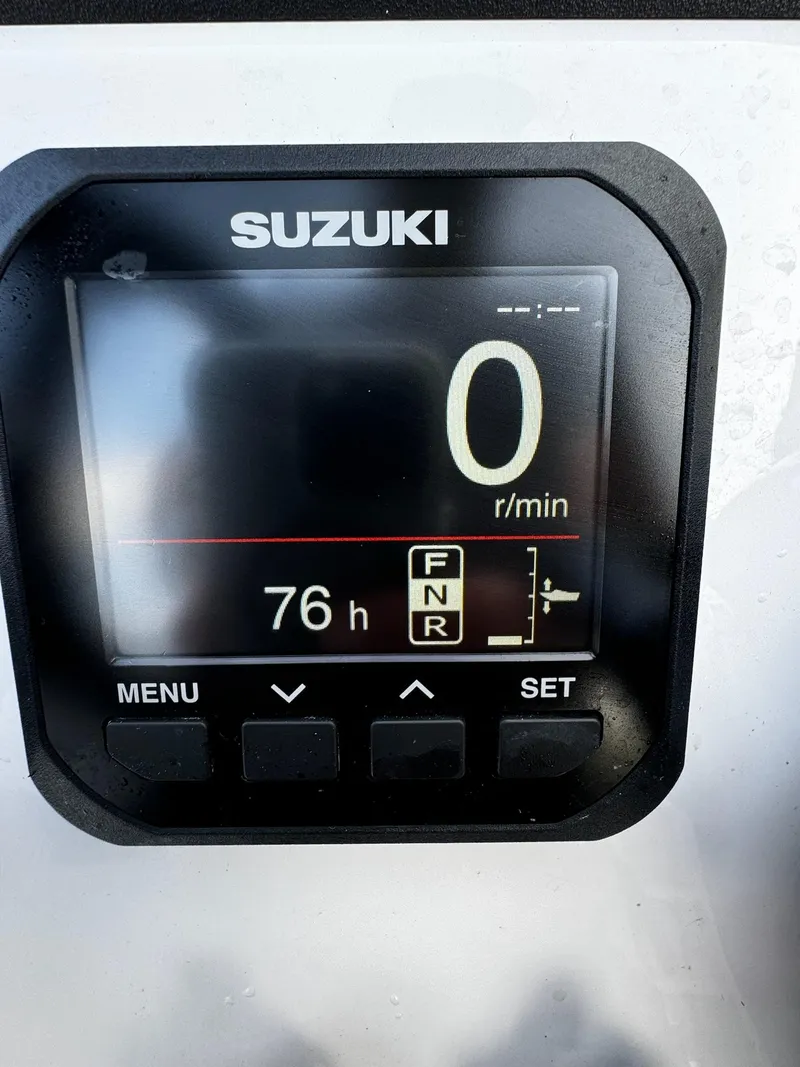Slide: The Image of Suzuki display on 2024 Mowdy 25 Catamaran showing 76 hours and zero RPM. - 27
