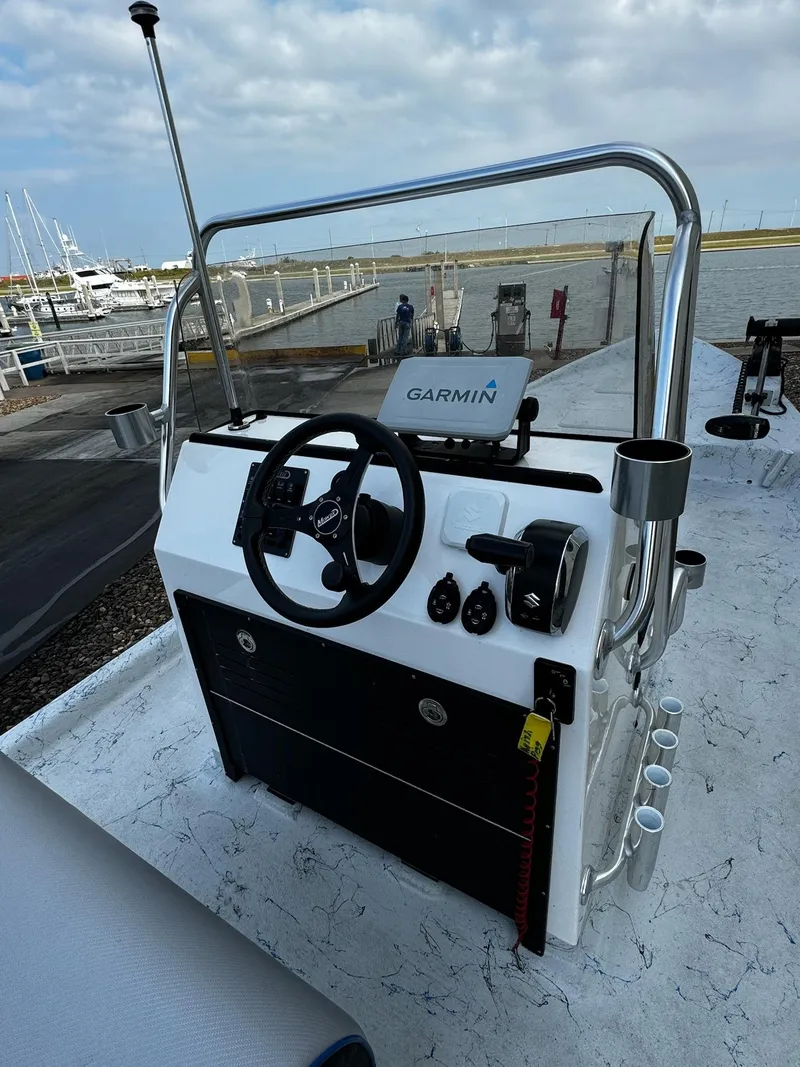 Slide: The Image of 2024 Mowdy 25 Catamaran boat console with Garmin navigation at marina. - 29