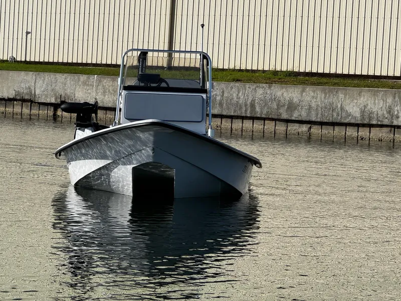 Slide: The Image of 2024 Mowdy 25 Catamaran boat on calm water near a dock. - 3