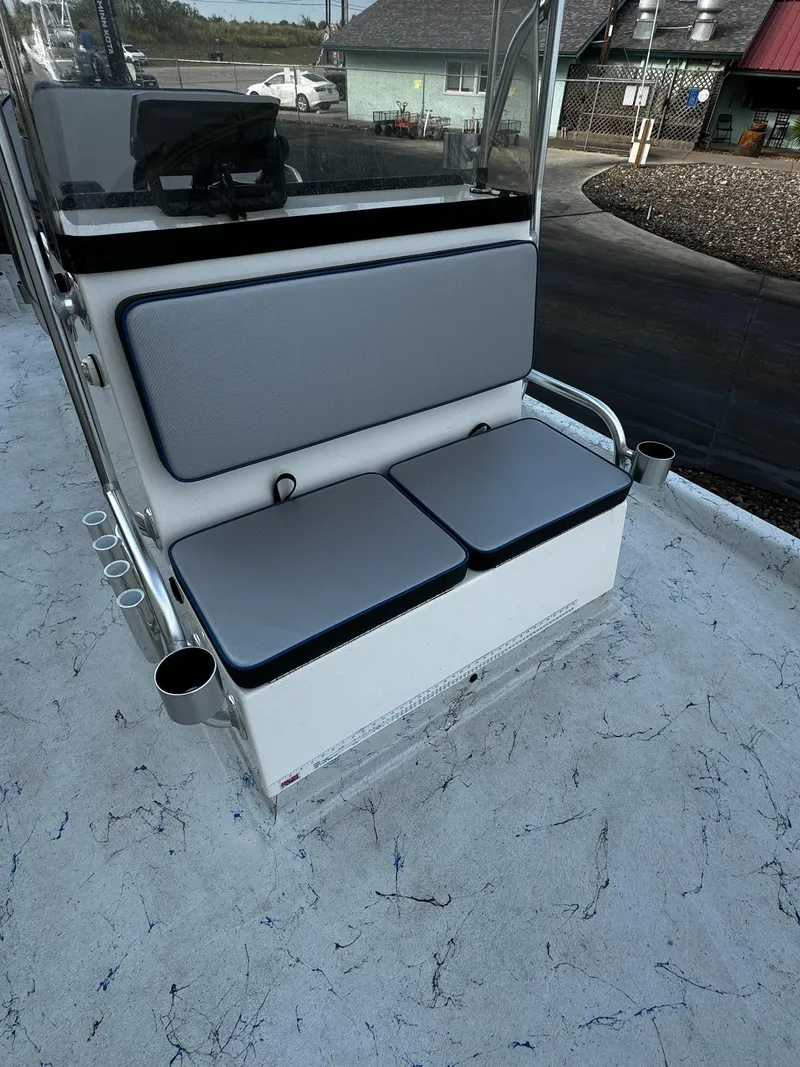 Slide: The Image of 2024 Mowdy 25 Catamaran boat seating with gray cushions and rod holders. - 30