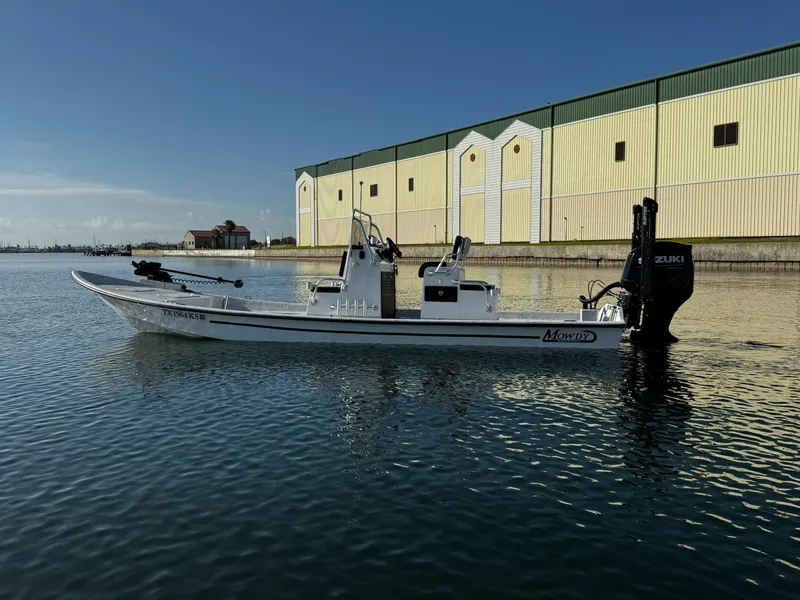 Slide: The Image of 2024 Mowdy 25 Catamaran boat on calm water near industrial building. - 4