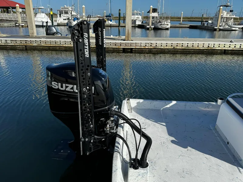 Slide: The Image of 2024 Mowdy 25 Catamaran with Suzuki outboard motor docked in marina. - 8