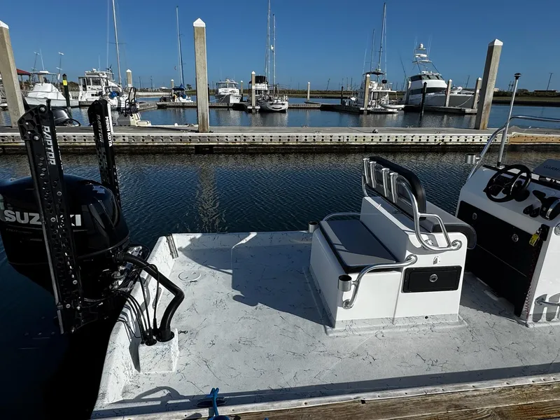 Slide: The Image of 2024 Mowdy 25 Catamaran docked at marina with Suzuki outboard motor. - 9