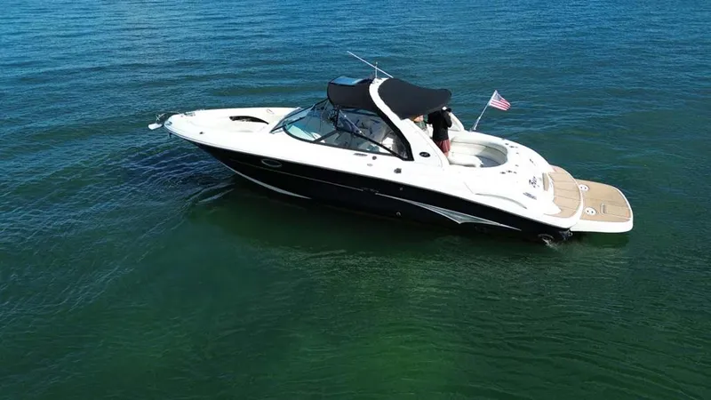 Slide: The Image of 2008 Sea Ray 290 SLX boat cruising on clear blue water. - 12