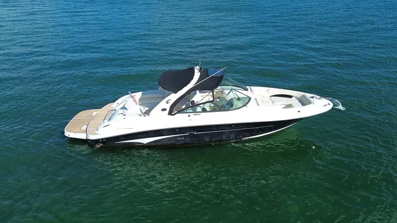 Slide: The Image of 2008 Sea Ray 290 SLX boat on open water, side view. - 13