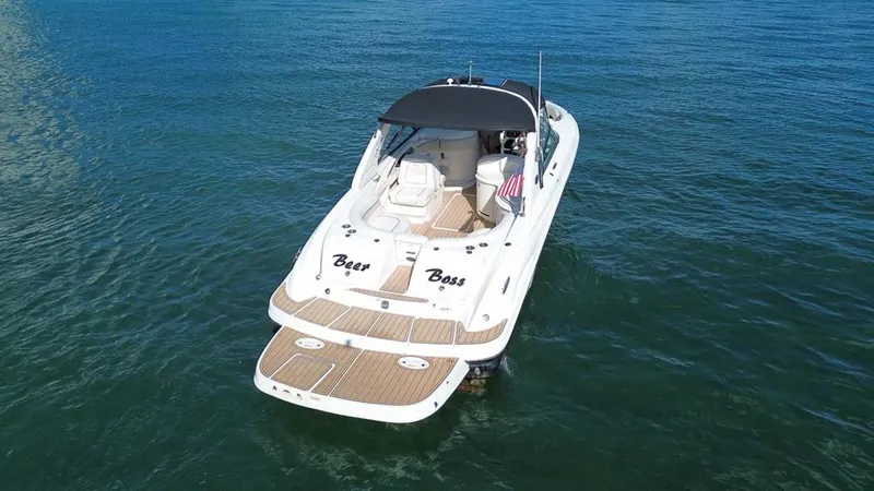 Slide: The Image of 2008 Sea Ray 290 SLX boat on water, rear view with canopy. - 16