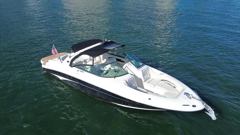 Slide: The Image of 2008 Sea Ray 290 SLX boat on calm water, featuring sleek design and American flag. - 23