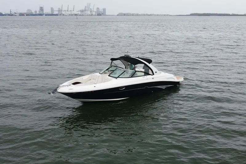 Slide: The Image of 2008 Sea Ray 290 SLX boat on calm water with industrial background. - 3