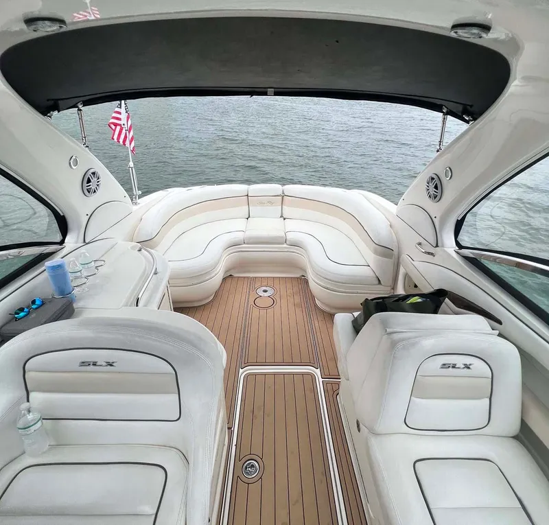 Slide: The Image of 2008 Sea Ray 290 SLX boat interior with white seating and wooden deck. - 4