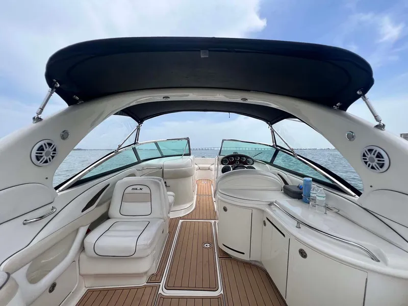 Slide: The Image of 2008 Sea Ray 290 SLX boat interior with seating and dashboard, under a clear blue sky. - 5