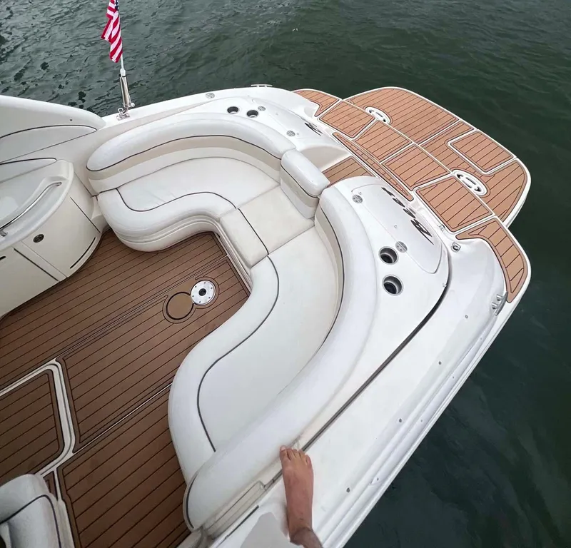 Slide: The Image of 2008 Sea Ray 290 SLX boat with white seating and teak deck on water. - 6