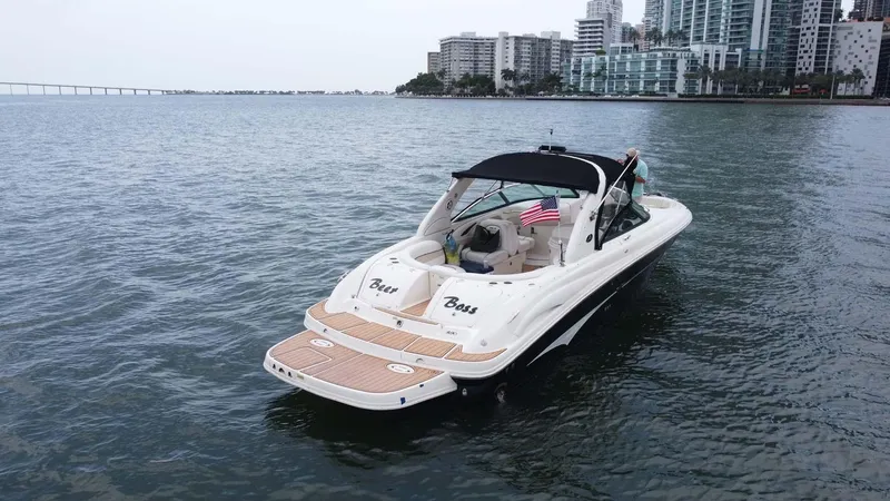 Slide: The Image of 2008 Sea Ray 290 SLX boat on water near city skyline. - 9