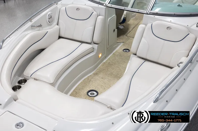 Slide: The Image of 2008 Crownline 240 EX boat interior with white seating and carpeted floor. - 10