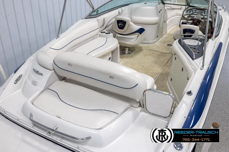 Slide: The Image of 2008 Crownline 240 EX boat interior with white seating and modern dashboard. - 12
