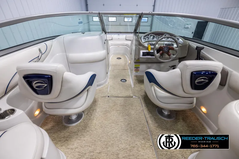 Slide: The Image of Interior of a 2008 Crownline 240 EX boat with plush seating and modern dashboard. - 14