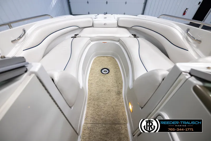 Slide: The Image of 2008 Crownline 240 EX boat interior with white seating and carpeted floor. - 15