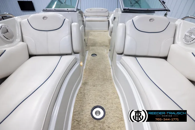 Slide: The Image of 2008 Crownline 240 EX boat interior with white seating and carpeted floor. - 16