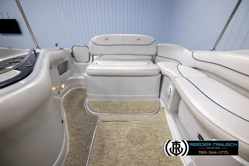 Slide: The Image of 2008 Crownline 240 EX boat interior with white seating and carpeted floor. - 18