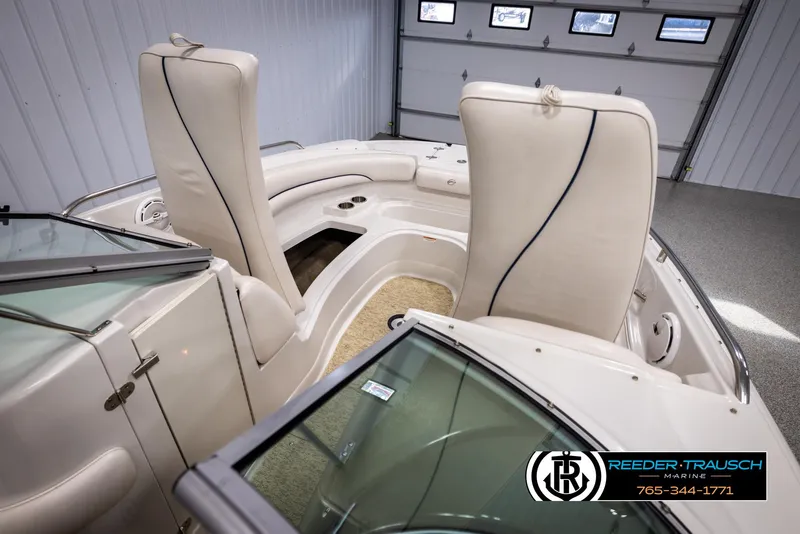 Slide: The Image of 2008 Crownline 240 EX boat interior with white seating and Reeder-Trausch Marine logo. - 20