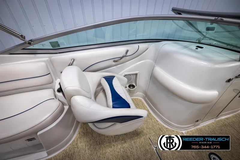 Slide: The Image of 2008 Crownline 240 EX boat interior with white seating and blue accents. - 22