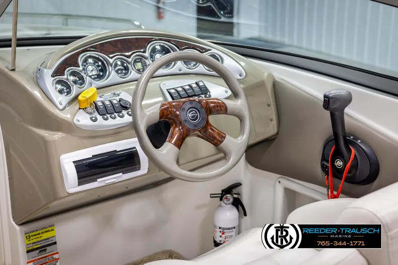 Slide: The Image of 2008 Crownline 240 EX boat dashboard with steering wheel and control panel. - 27