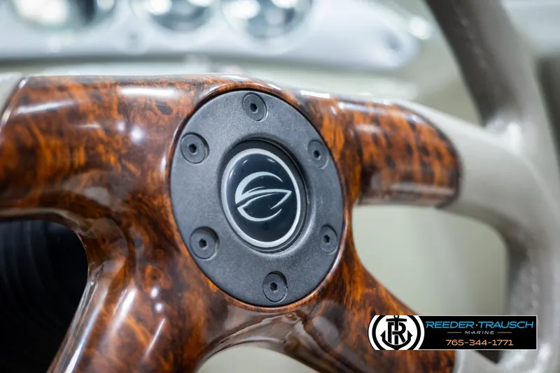 Slide: The Image of Close-up of 2008 Crownline 240 EX steering wheel with wood finish and logo. - 28
